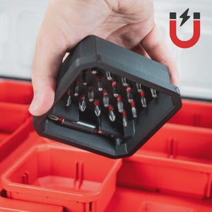 May include: A black magnetic bit holder with multiple screwdriver bits, held over a red storage container. The bits have red and silver accents. A red and black magnet icon is in the background.