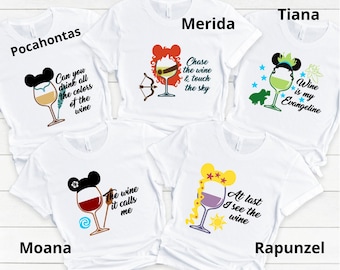 May include: Five white t-shirts with different Disney princess characters and wine glasses. The shirts feature the text "Pocahontas", "Merida", "Tiana", "Moana", and "Rapunzel". Each shirt has a different quote about wine.