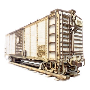 May include: A wooden model of a boxcar train carriage with the text "584208 RIDLW CAPY 100000 LMT 124700 BL 2-03" printed on the side.