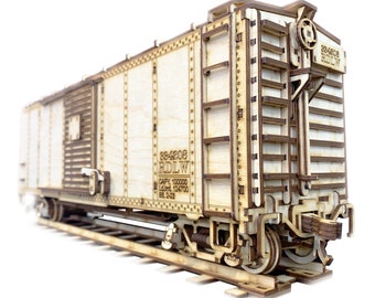 May include: A wooden model of a boxcar train car with the text "584208 RIDLW CAPY 100000 LMT 124700 BL 2-03" printed on the side.
