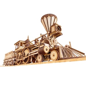 May include: A wooden model of a vintage steam locomotive train with a large smokestack and detailed wheels. The train is on a wooden track and is made of light brown wood.