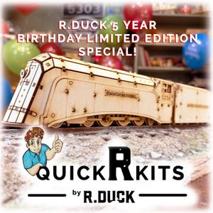 May include: A wooden model train kit featuring the Commodore Duckbill locomotive with detailed paneling and wheels. The text R.DUCK 5 YEAR BIRTHDAY LIMITED EDITION SPECIAL! appears above, and the logo QUICK R KITS by R.DUCK is at the bottom.