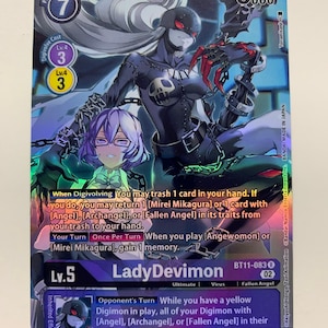 May include: A LadyDevimon Digimon card with a holographic finish. The card features a black and purple illustration of the Digimon with a skull and chains. The card text reads "When Digivolving You may trash 1 card in your hand. If you do, you may return 1 [Mirei Mikagura] or 1 card with [Angel], [Archangel], or [Fallen Angel] in its traits from your trash to your hand. Your Turn Once Per Turn When you play [Angewomon] or [Mirei Mikagura], gain 1 memory. Opponent's Turn While you have a yellow Digimon in play, all of your Digimon with [Angel], [Archangel], or [Fallen Angel] in their traits gain Retaliation."