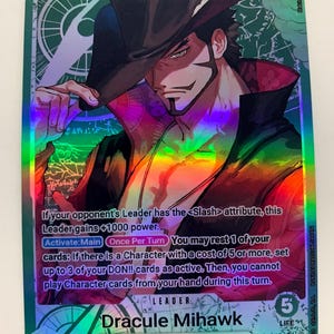 May include: A holographic trading card featuring Dracule Mihawk from "The Seven Warlords of the Sea." The card displays a character illustration with a black hat and a detailed background. The card has a 5000 power rating and includes game text.