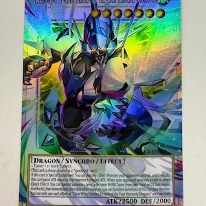 May include: A holographic trading card featuring the Clear Wing Synchro Dragon of the Four Heavenly Dragons. The card has a dragon illustration with blue, black, and white accents. Text includes card type, effects, ATK/DEF stats, and copyright information.