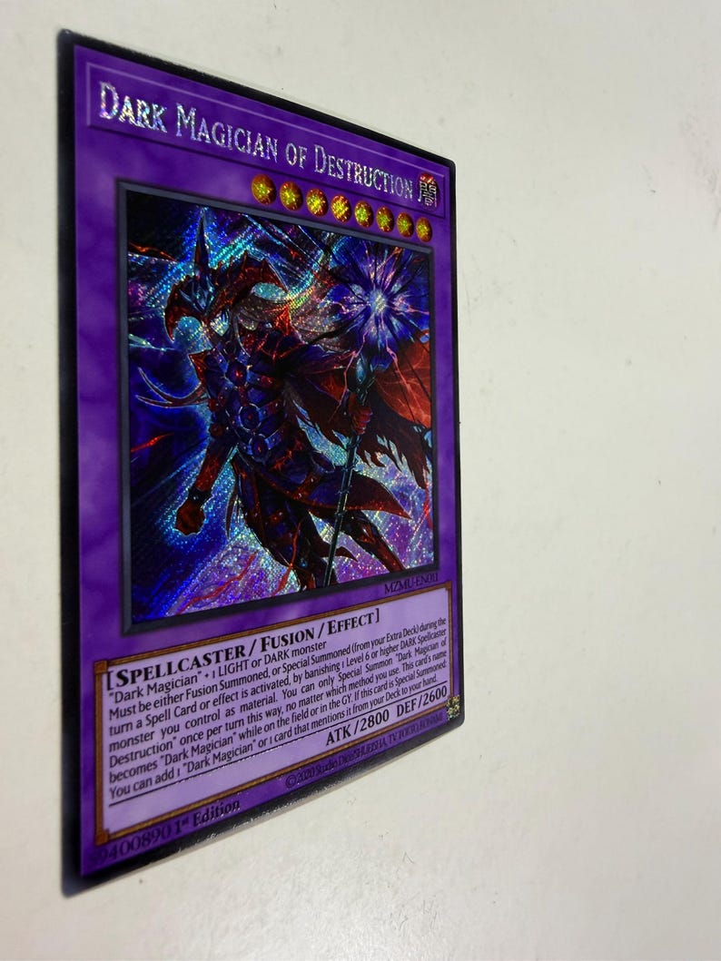 May include: A holographic trading card featuring the character "Dark Magician of Destruction" with a purple border. The card has text describing its abilities and stats, including ATK/2800 and DEF/2600. The card is a collectible item.