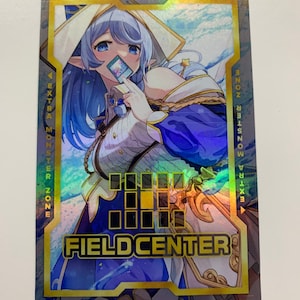 May include: A holographic trading card featuring a blue-haired anime character with a white and blue outfit. The card has a gold border and the text "FIELD CENTER" in black letters.