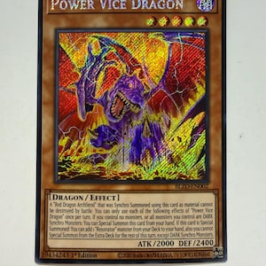 May include: A holographic trading card featuring "Power Vice Dragon." The card has a brown border and a vibrant illustration of a purple dragon with red and yellow accents. Text includes "DRAGON/EFFECT" and card details.