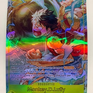 May include: A holographic trading card featuring Monkey D. Luffy from the Sky Island/Straw Hat Crew. The card has a dynamic illustration of Luffy in action, with a power level of 7000. Text on the card details character abilities.