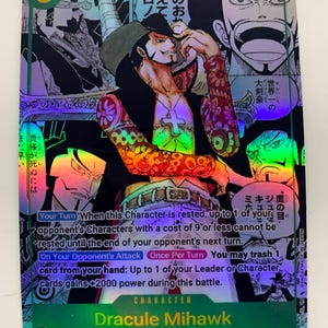May include: A holographic trading card featuring Dracule Mihawk from "The Seven Warlords of the Sea." The card has a green border and includes Japanese text, character details, and game instructions. The artwork depicts a character with a hat and cross-shaped pendant.
