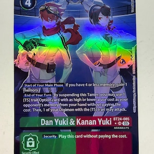 May include: A holographic Digimon trading card featuring Dan Yuki and Kanan Yuki with a play cost of 4. The card displays text including Start of Your Main Phase, End of Your Turn, and Security effect. It is labelled BT24-085 and includes character art.