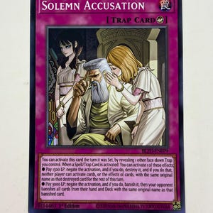 May include: A trading card titled "Solemn Accusation" with a purple border. The card features an illustration of three figures in classical attire. Text on the card describes its effects. The card is a Trap Card.