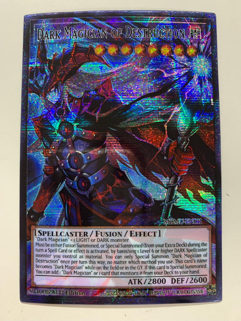 May include: A holographic trading card featuring the character "Dark Magician of Destruction." The card has a dark color scheme with red, blue, and purple accents. Text includes card type, effect details, and attack/defense stats. The card is a collectible item.