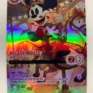 May include: A holographic trading card featuring Mickey Mouse as the Brave Little Prince, riding a carousel horse. The card has a red and gold color scheme, with the number 3 in the upper left corner and the text "MICKEY MOUSE" at the top.