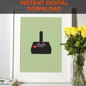 May include: A digital download of a minimalist illustration of a vintage joystick on a green background. The joystick is black with a red button and a black stick.