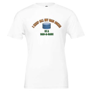 Op de afbeelding: Wit T-shirt met een groene en oranje afbeelding met de tekst "Ik bewaar al mijn vadersmoppen in een vadersdatabase". De afbeelding bevat ook een blauw database-icoon.