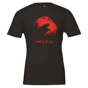 May include: Black t-shirt with a red graphic of Godzilla roaring in front of a red sun. The Japanese word "ゴジラ" is printed below the graphic.