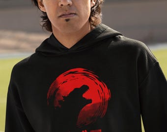 May include: A black hoodie with a red Japanese-style sun graphic featuring a silhouette of Godzilla. The text "ゴジラ" is printed in red below the graphic.