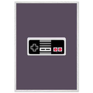 May include: A black and gray video game controller with two red buttons. The controller is on a purple background.