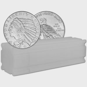 May include: Two silver coins with detailed engravings of a Native American in a headdress and an eagle. The coins are partially visible, resting on a white plastic coin tube. The coins are likely collectible or investment items.
