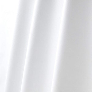 May include: White fabric with smooth, flowing folds. The fabric is wrinkle-free and has a silky sheen.