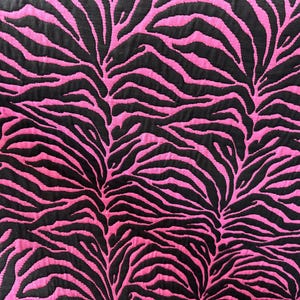 May include: Pink and black fabric with a zebra print pattern.