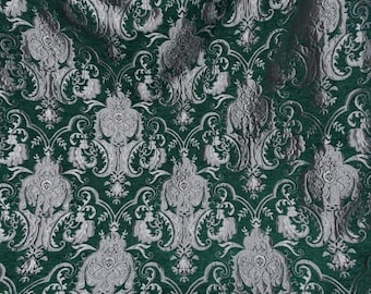 May include: Green fabric with a silver damask pattern. The fabric has a raised texture and a luxurious feel.