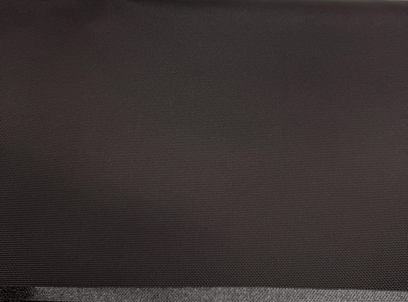 May include: A dark brown fabric with a subtle textured pattern. The fabric has a smooth, even surface.