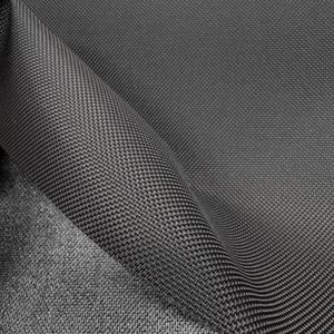 May include: Close-up of a dark gray fabric with a textured weave. The fabric is folded over itself, showing the underside of the material.