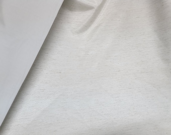 May include: Close-up of a white fabric with a subtle textured pattern. The fabric is smooth and appears to be made of a high-quality material.
