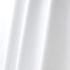 May include: White fabric with smooth, flowing folds. The fabric is wrinkle-free and has a soft, silky texture.