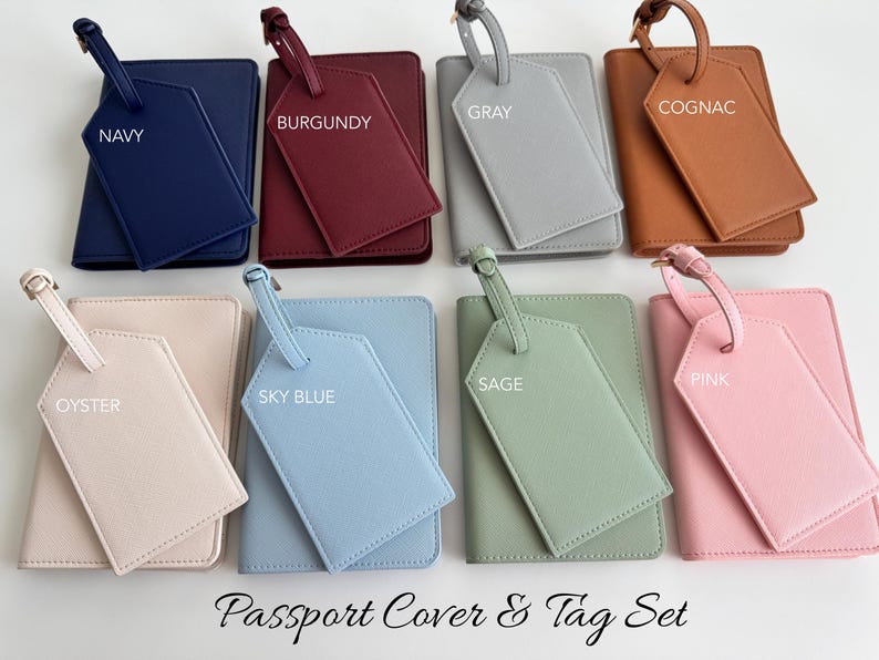 May include: Eight passport cover and luggage tag sets in various colors including navy, burgundy, gray, cognac, oyster, sky blue, sage, and pink. Each set features a rectangular passport holder and a matching luggage tag with a strap. The text Passport Cover & Tag Set is displayed at the bottom.