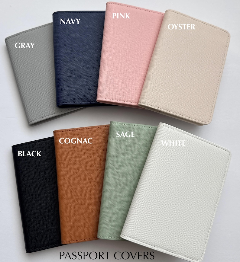 May include: A collection of passport covers in various colors, including gray, navy, pink, oyster, black, cognac, sage, and white. Each cover is labeled with its color name. The text "PASSPORT COVERS" is at the bottom.