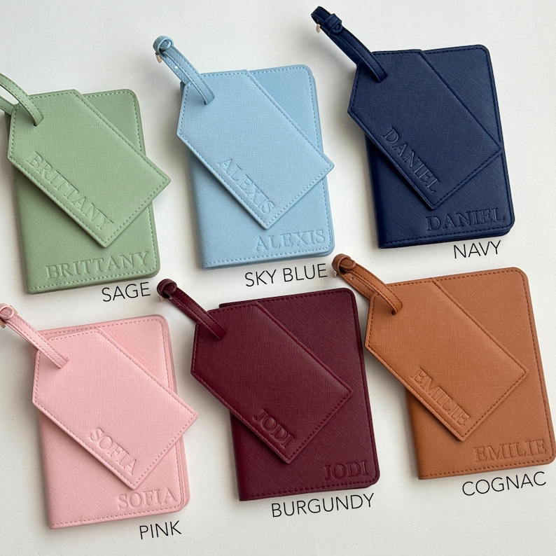 May include: A collection of personalized travel accessories, including passport holders and luggage tags. The items are in various colors: sage, sky blue, navy, pink, burgundy, and cognac. Each piece is embossed with a name.