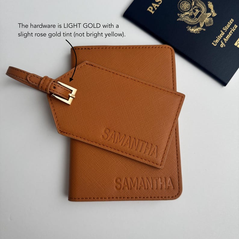May include: A brown passport holder and luggage tag with the name "SAMANTHA" embossed on them. The luggage tag has a light gold buckle. A United States passport is visible in the background.