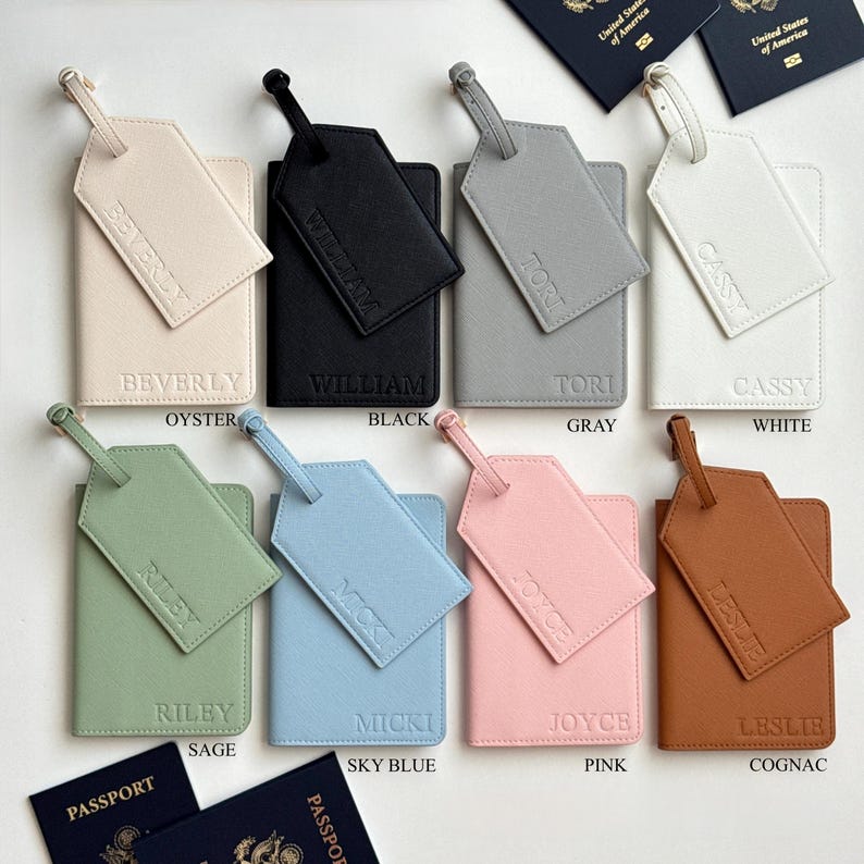 May include: A collection of personalized passport holders and luggage tags in various colors, including oyster, black, gray, white, sage, sky blue, pink, and cognac. Each set features a matching tag and holder with a name embossed on each.