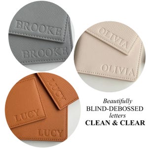 May include: Close-up of three personalized leather goods in gray, tan, and brown. Each item features a name blind-debossed in capital letters: BROOKE, OLIVIA, and LUCY. The text "Beautifully BLIND-DEBOSSED letters CLEAN & CLEAR" is also visible.