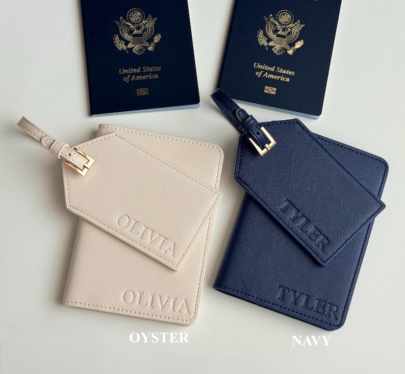 May include: Two United States of America passports are displayed with two personalized travel sets. One set is oyster-colored with "OLIVIA" embossed, and the other is navy blue with "TYLER" embossed. Each set includes a passport holder and luggage tag.