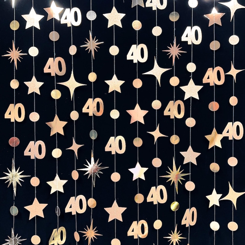May include: Gold glitter garland with stars and the number 40 repeated throughout. This garland is perfect for a 40th birthday party.