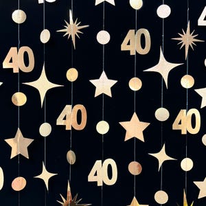 May include: Gold glitter garland with stars and the number 40. The garland is perfect for a 40th birthday party.