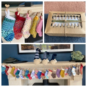May include: A set of 24 colourful crocheted stockings hanging on a fireplace mantel with wooden pegs. Each stocking has a heart-shaped tag with a number on it. There are three crocheted gnomes on the mantel.
