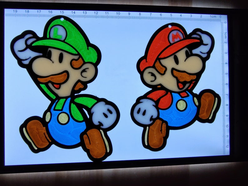 Puede incluir: Dos personajes de dibujos animados, Mario y Luigi, se representan en una pose de carrera. Mario lleva un sombrero rojo y un mono, mientras que Luigi lleva un sombrero verde y un mono. Ambos personajes est&aacute;n delineados en negro y tienen ojos blancos. Los personajes est&aacute;n sobre un fondo blanco con una regla en el fondo.
