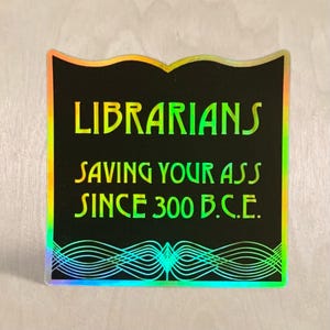 Librarians Saving Your Ass black and gold holographic stickers for Librarians and those who love libraries