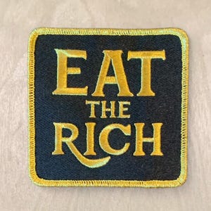 リッチなエレガントな黒と金の刺繍パッチを食べる