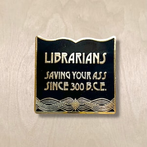 Librarians Saving Your Ass Book Shaped Hard Enamel Pin Gold and Black Deco Style for Librarians and Library Lovers