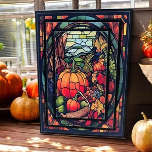 May include: A framed artwork with a stained-glass effect, featuring a vibrant autumn harvest scene. The artwork showcases pumpkins, grapes, and fall foliage in shades of orange, red, and green. The frame is black, and the artwork is displayed on a wooden surface.