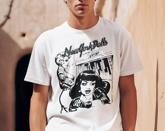 May include: A white t-shirt with a black and white graphic print of two women and the text "New York Dolls with the Dolls".