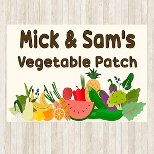 May include: A rectangular sign with the text "Mick & Sam's Vegetable Patch" in brown. The bottom of the sign features a colourful illustration of various fruits and vegetables, including a pineapple, watermelon, and carrots.