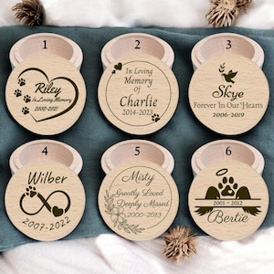 May include: Six wooden boxes with lids, each featuring a personalised memorial inscription for a pet. The inscriptions include the pet's name, dates, and a short message. The boxes are ideal for storing ashes or other mementos.