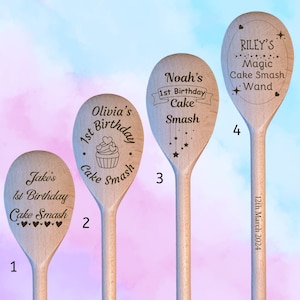 May include: Four wooden spoons with personalised engravings for a first birthday cake smash. The spoons are decorated with hearts, stars, and a cupcake design. The text on the spoons reads "Jake's 1st Birthday Cake Smash", "Olivia's 1st Birthday Cake Smash", "Noah's 1st Birthday Cake Smash", and "Riley's Magic Cake Smash Wand".
